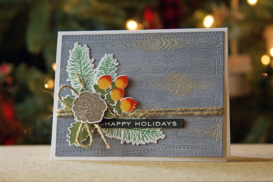 A weathered wood background for holiday cards using Copic markers and texture paste.