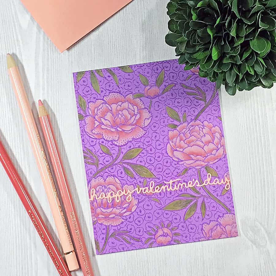 A Hand-Colored Floral Valentine, completed card. Rosy pink flowers colored with opaque pencils over a bright purple background.