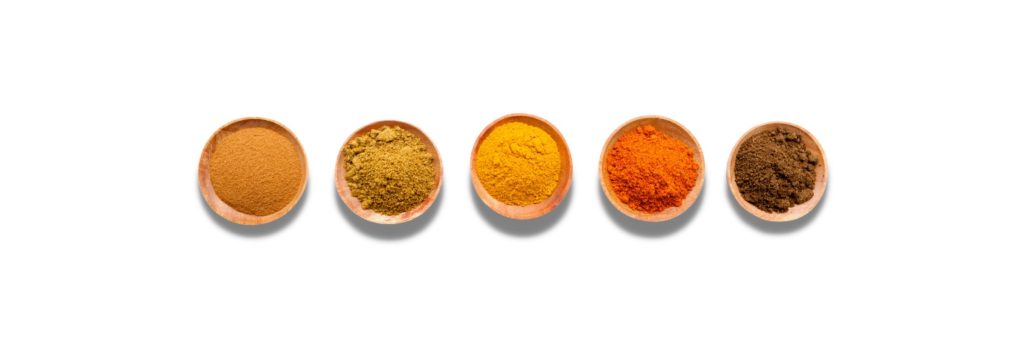 Pinch bowls of spices for a garam masala spice mix.